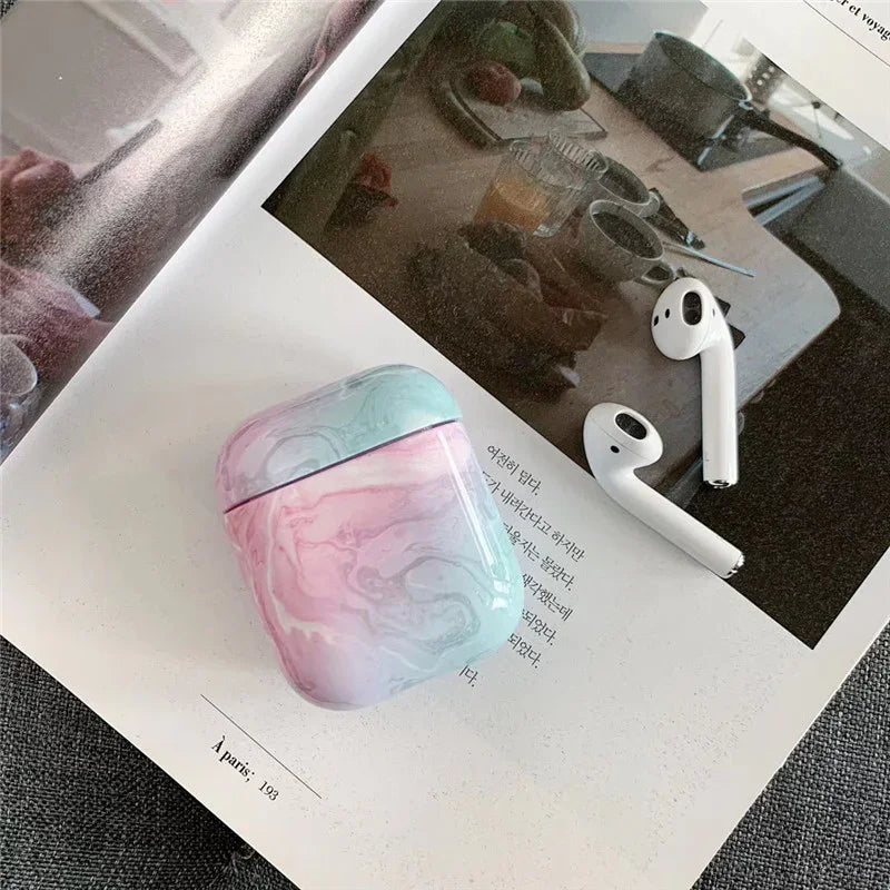 Marble pastel AirPods case with wireless earbuds on open magazine