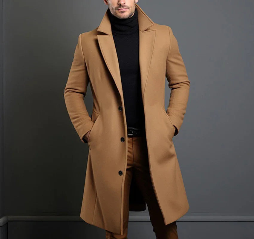 Stylish man wearing a camel overcoat with black turtleneck and tan pants