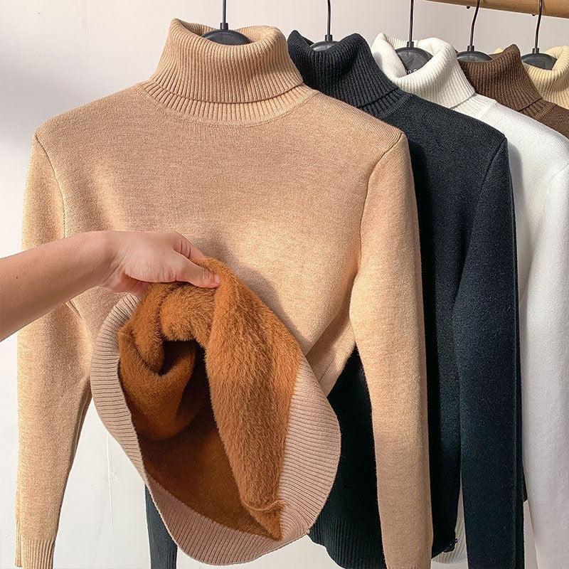 Assorted fleece-lined turtleneck sweaters in neutral colors hanging on a rack