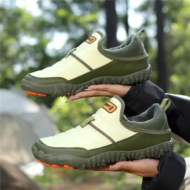 Outdoor slip-on hiking shoes with green and beige design, rugged sole, and orange accents